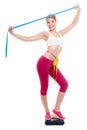 Diet. Fit girl with measure tape on weight scale Royalty Free Stock Photo