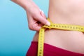 Diet. Fitness woman fit girl with measure tape measuring her waist Royalty Free Stock Photo