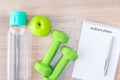 Diet food, fitness concept with dumbbell, fruit, bottle of drink water and notebook