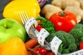 Diet food, fork and measuring tape, closeup