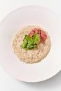 Diet food oatmeal porridge with spinach and ham in the plate. Royalty Free Stock Photo