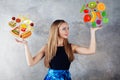 Diet girl chooses between food Royalty Free Stock Photo