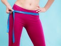Diet. Girl with measure tape measuring loins