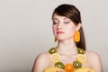 Diet. Girl with necklace of fresh citrus fruits