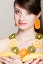 Diet. Girl with necklace of fresh citrus fruits