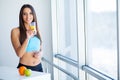 Diet. Happy smiling young woman drinking orange juice Royalty Free Stock Photo