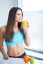 Diet. Happy smiling young woman drinking orange juice Royalty Free Stock Photo