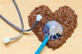 Raw flax seeds heart shaped and stethoscope Royalty Free Stock Photo