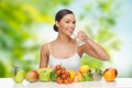 Woman with healthy food on table drinking water