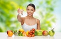 Woman with healthy food on table drinking water