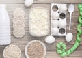 Diet, healthy food. Bottle of yogurt, crispy round bread, buckwheat noodles, oatmeal, cottage cheese, egg tray on a wooden table. Royalty Free Stock Photo