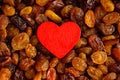 Diet healthy food. Raisin as background texture and red heart