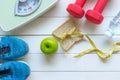 Diet and Healthy life loss weight Concept. Green apple and Weight scale measure tap with fresh vegetable and sport equipment for w Royalty Free Stock Photo