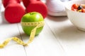 Diet and Healthy life loss weight Concept. Green apple and Weight scale measure tap with fresh vegetable and sport equipment for w Royalty Free Stock Photo