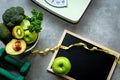 Diet and Healthy life loss weight Concept. Green apple and Weight scale measure tap with fresh vegetable and sport equipment for w Royalty Free Stock Photo