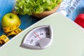 Diet and Healthy life loss weight Concept. Green apple and Weight scale measure tap with fresh vegetable