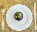 Diet, healthy mangosteen on the white plate - healthy breakfast, weight loss concept Royalty Free Stock Photo