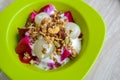 Diet healthy meal, Rambutan, dragon fruits, multigrain, and granola with yogurt in green bowl