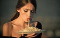 Diet and healthy organic food, italy. Chef woman with red lips eat pasta. Hunger, appetite, recipe. Woman eating pasta