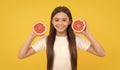 diet and kid skin beauty. positive teen girl with grapefruit. vitamin and dieting.
