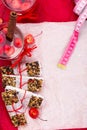 Diet muesli bars with detox apple cinnamon water and measuring tape on red pepper and wooden background. Top view. Flat lay. Royalty Free Stock Photo