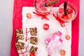 Diet muesli bars with detox apple cinnamon water and measuring tape on red pepper and wooden background. Top view. Flat lay. Royalty Free Stock Photo