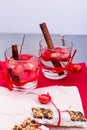 Diet muesli bars with detox apple cinnamon water on red pepper and wooden background. Royalty Free Stock Photo