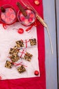 Diet muesli bars with detox apple cinnamon water on red pepper and wooden background. Top view. Flat lay. Royalty Free Stock Photo