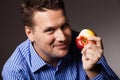 Diet nutrition. Happy man eating apple fruit Royalty Free Stock Photo