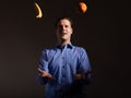 Diet nutrition. Man juggling with tropical fruits