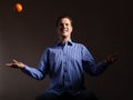 Diet nutrition. Man throwing orange tropical fruit