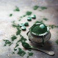 Superfood concept ground green spirulina algae powder, pills tablets Royalty Free Stock Photo