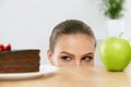 Diet And Nutrition. Woman Choosing Between Cake And Apple. Royalty Free Stock Photo