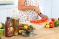 Diet, nutrition and a woman cooking in the kitchen, cutting ingredients in preparation of a food meal. Hands, knife and