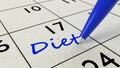 Diet paper calendar entry and blue pen