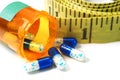 Diet Pills and Tape Measure Closeup