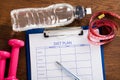 Diet Plan With Dumbbell, Water Bottle And Measuring Tape Royalty Free Stock Photo