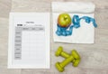 Diet plan, green weights, apple, measure tape and towel Royalty Free Stock Photo