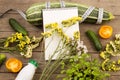 marrow squash, measure tape, blank notepad, bottle of water, flowers, tomatoes and cucumbers on brown wooden table Royalty Free Stock Photo