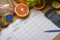 Diet plan, tape measure, water, diet of fresh fruits on the wooden floor Royalty Free Stock Photo