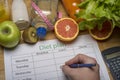 Diet plan, tape measure, water, diet of fresh fruits on the wooden floor Royalty Free Stock Photo