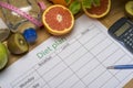 Diet plan, tape measure, water, diet of fresh fruits on the wooden floor Royalty Free Stock Photo