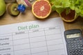 Diet plan, tape measure, water, diet of fresh fruits on the wooden floor Royalty Free Stock Photo