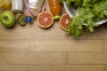 Diet plan, tape measure, water, diet of fresh fruits on the wooden floor Royalty Free Stock Photo