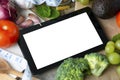 Diet plannig. Set of raw food with tablet on wooden background with gadget screen with copy space. Healthy food concept