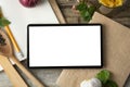 Diet plannig. Set of raw food with tablet on wooden background with gadget screen with copy space. Healthy food concept