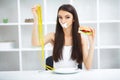 Diet. Portrait woman wants to eat a Burger but stuck skochem mouth, the concept of diet, junk food, willpower in nutrition Royalty Free Stock Photo