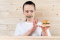 Diet. Portrait woman wants to eat a Burger but stuck skochem mouth, the concept of diet, junk food, willpower in nutrition Royalty Free Stock Photo