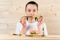 Diet. Portrait woman wants to eat a Burger but stuck skochem mouth, the concept of diet, junk food, willpower in nutrition Royalty Free Stock Photo