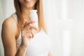 Diet. Pretty young woman looking at camera while eating yogurt in the kitchen at home Royalty Free Stock Photo